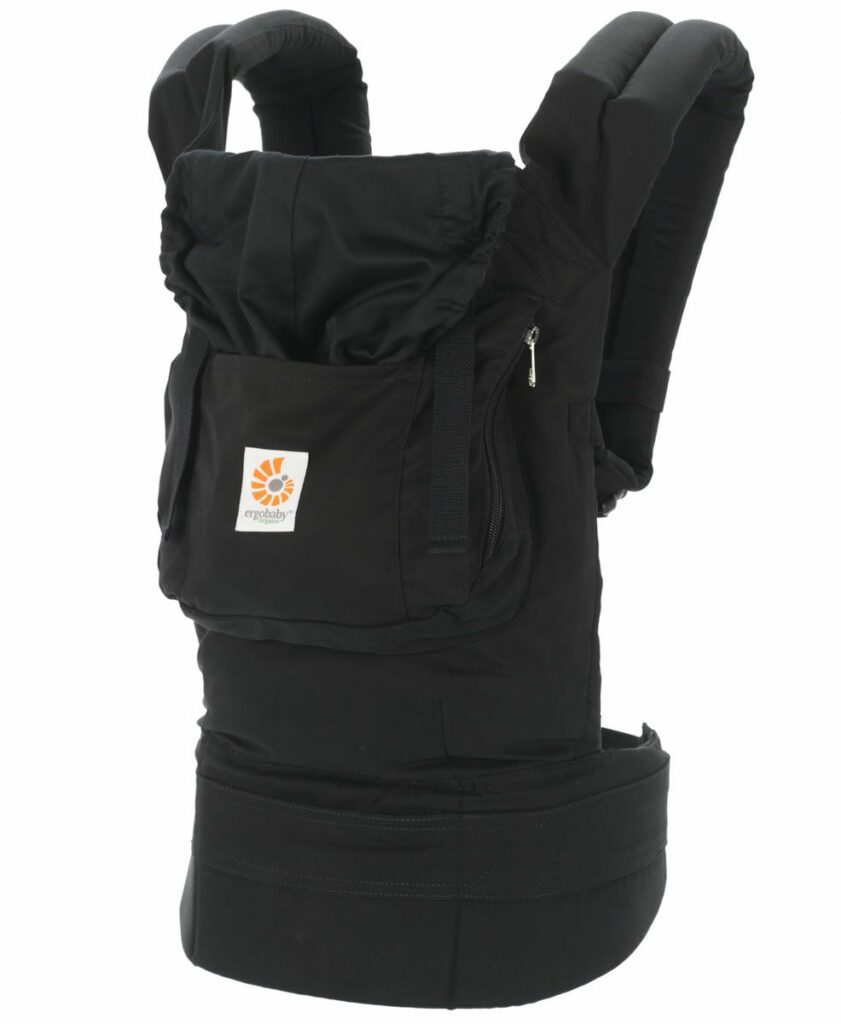 A black ergobaby carrier with a while background. 
