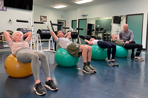 Michael Moore teaches a class using exercise balls. 