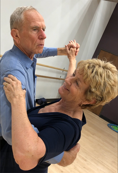 Michael and his wife ballroom dance in a dance studio. 